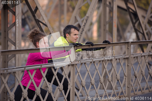 Image of couple warming up before jogging