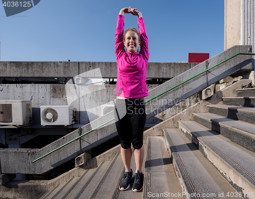 Image of woman  stretching before morning jogging