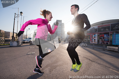 Image of couple warming up before jogging