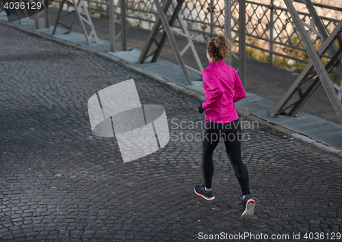 Image of sporty woman jogging on morning