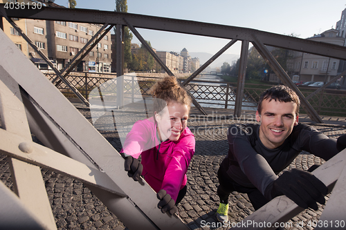 Image of couple warming up before jogging