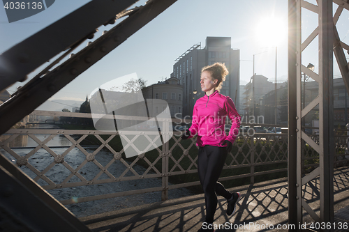 Image of sporty woman jogging on morning