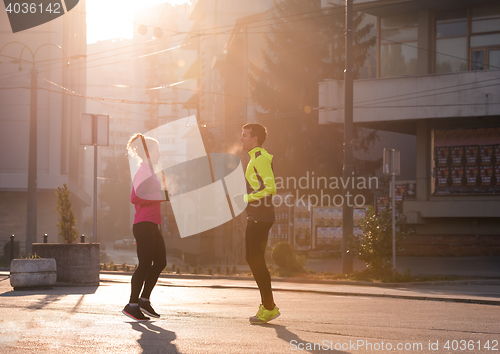 Image of couple warming up before jogging