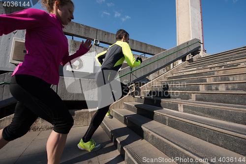 Image of young  couple jogging on steps