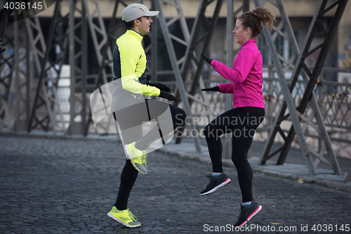 Image of couple warming up before jogging