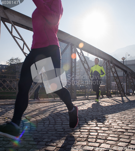 Image of sporty woman jogging on morning