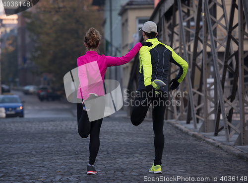 Image of couple warming up before jogging