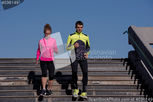 Image of young  couple jogging on steps