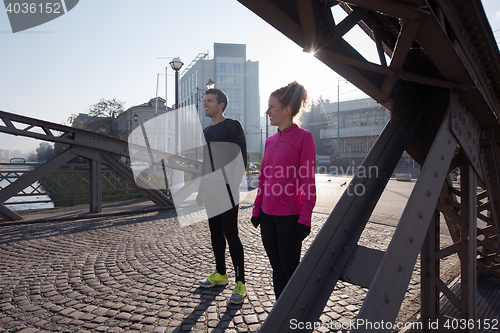 Image of couple warming up before jogging