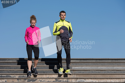 Image of young  couple jogging on steps