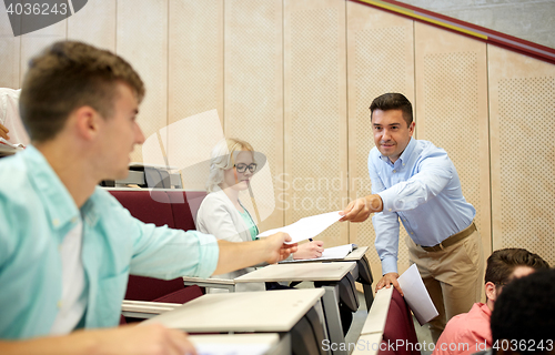 Image of teacher giving tests to students at lecture