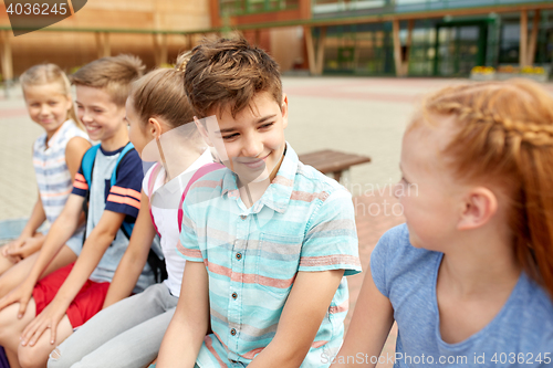 Image of group of happy elementary school students talking