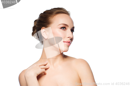 Image of beautiful young woman touching her neck