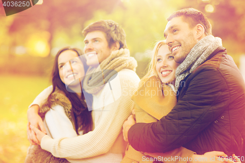 Image of group of friends having fun in autumn park