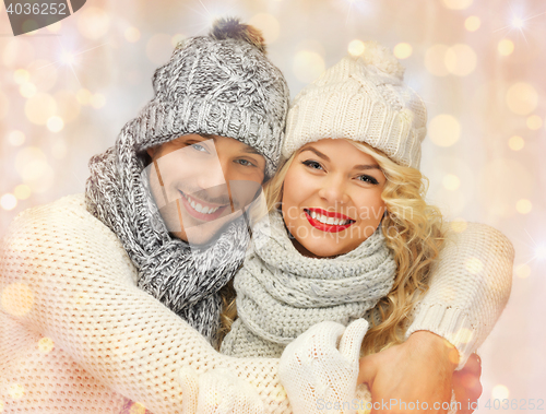 Image of happy family couple in winter clothes hugging