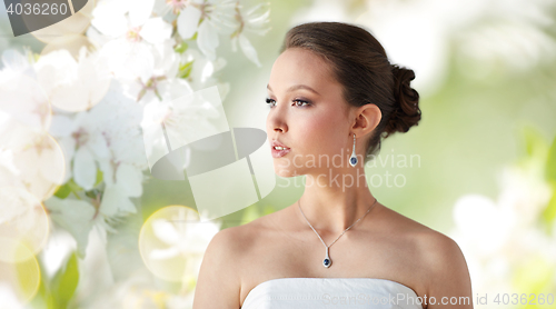 Image of beautiful asian woman with earring and pendant