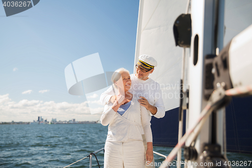 Image of senior couple hugging on sail boat or yacht in sea