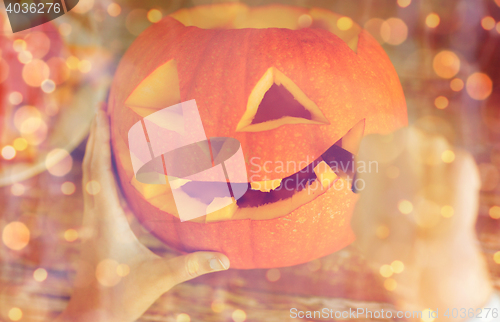 Image of close up of woman with pumpkins at home