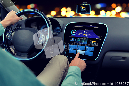 Image of close up of man driving car with navigation system