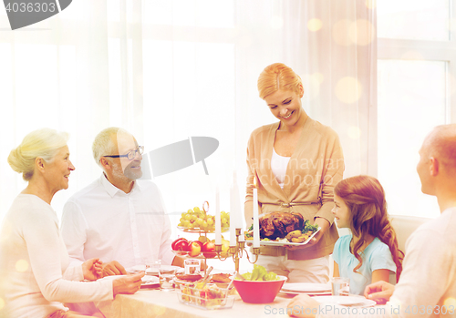 Image of smiling family having holiday dinner at home