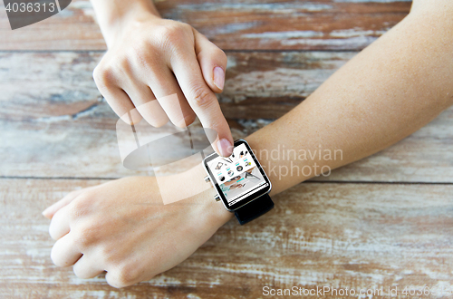 Image of close up of hands with online shop on smart watch