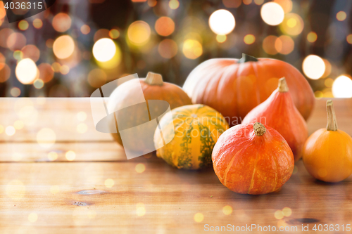 Image of close up of halloween pumpkins on wooden table