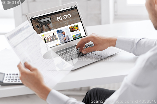 Image of businessman with laptop computer working at office