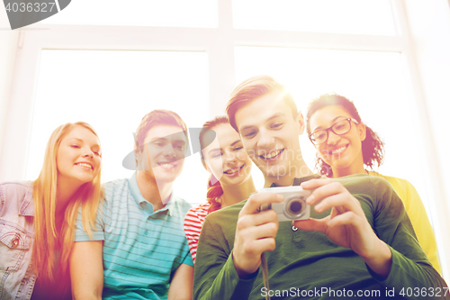 Image of smiling students with digital camera at school