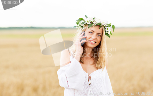 Image of happy young woman calling on smartphone at country