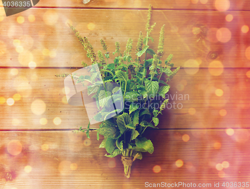 Image of close up of fresh melissa bunch on wooden table