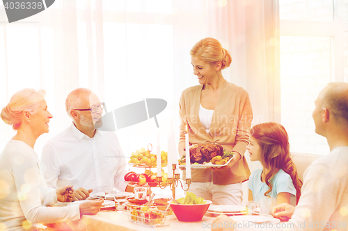 Image of smiling family having holiday dinner at home