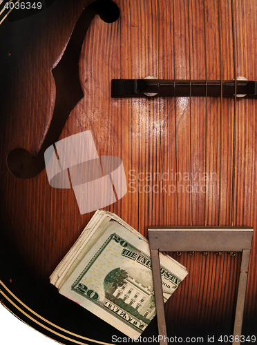 Image of Vintage Acoustic Guitar And Money