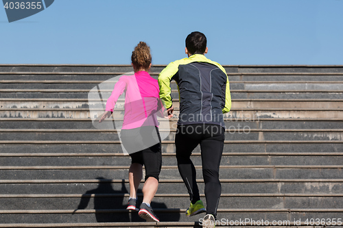 Image of young  couple jogging on steps