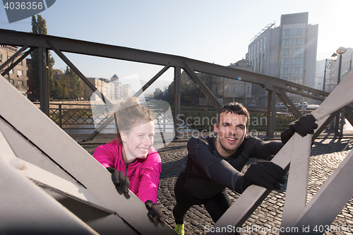 Image of couple warming up before jogging