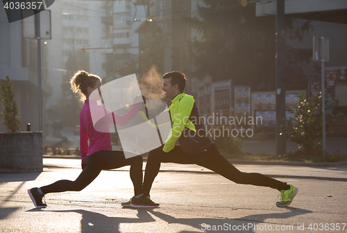 Image of couple warming up before jogging