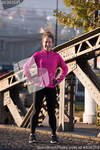 Image of woman  stretching before morning jogging