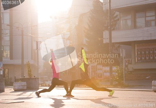 Image of couple warming up before jogging