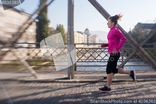 Image of sporty woman jogging on morning