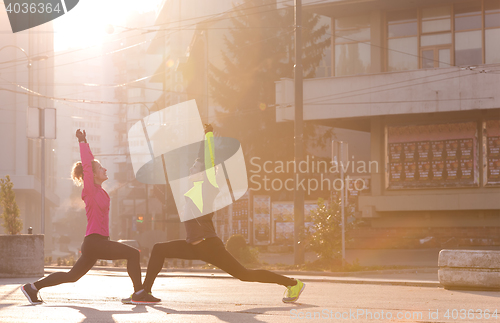 Image of couple warming up before jogging