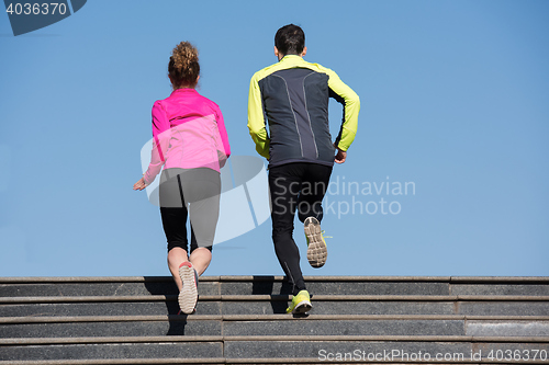 Image of young  couple jogging on steps