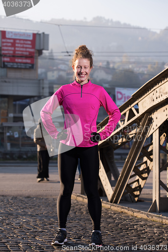 Image of woman  stretching before morning jogging