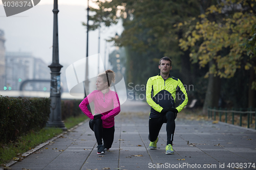 Image of couple warming up before jogging