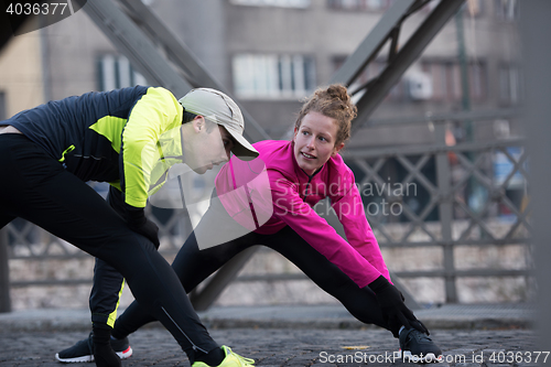 Image of couple warming up before jogging