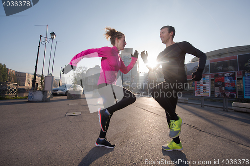 Image of couple warming up before jogging