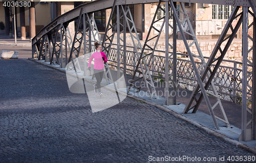 Image of sporty woman jogging on morning