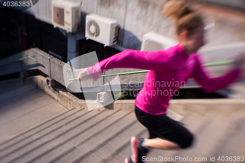 Image of woman jogging on  steps