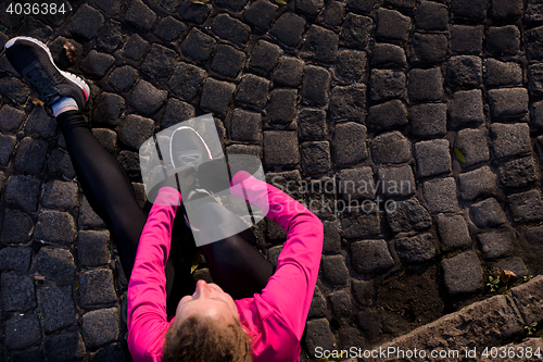 Image of woman  stretching before morning jogging