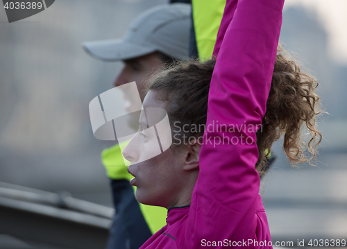 Image of couple warming up before jogging