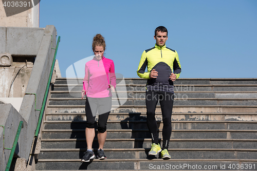 Image of young  couple jogging on steps