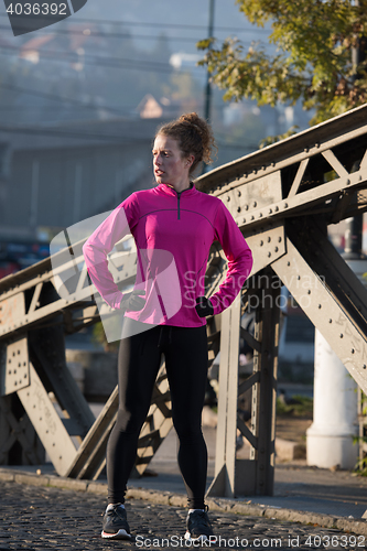 Image of woman  stretching before morning jogging